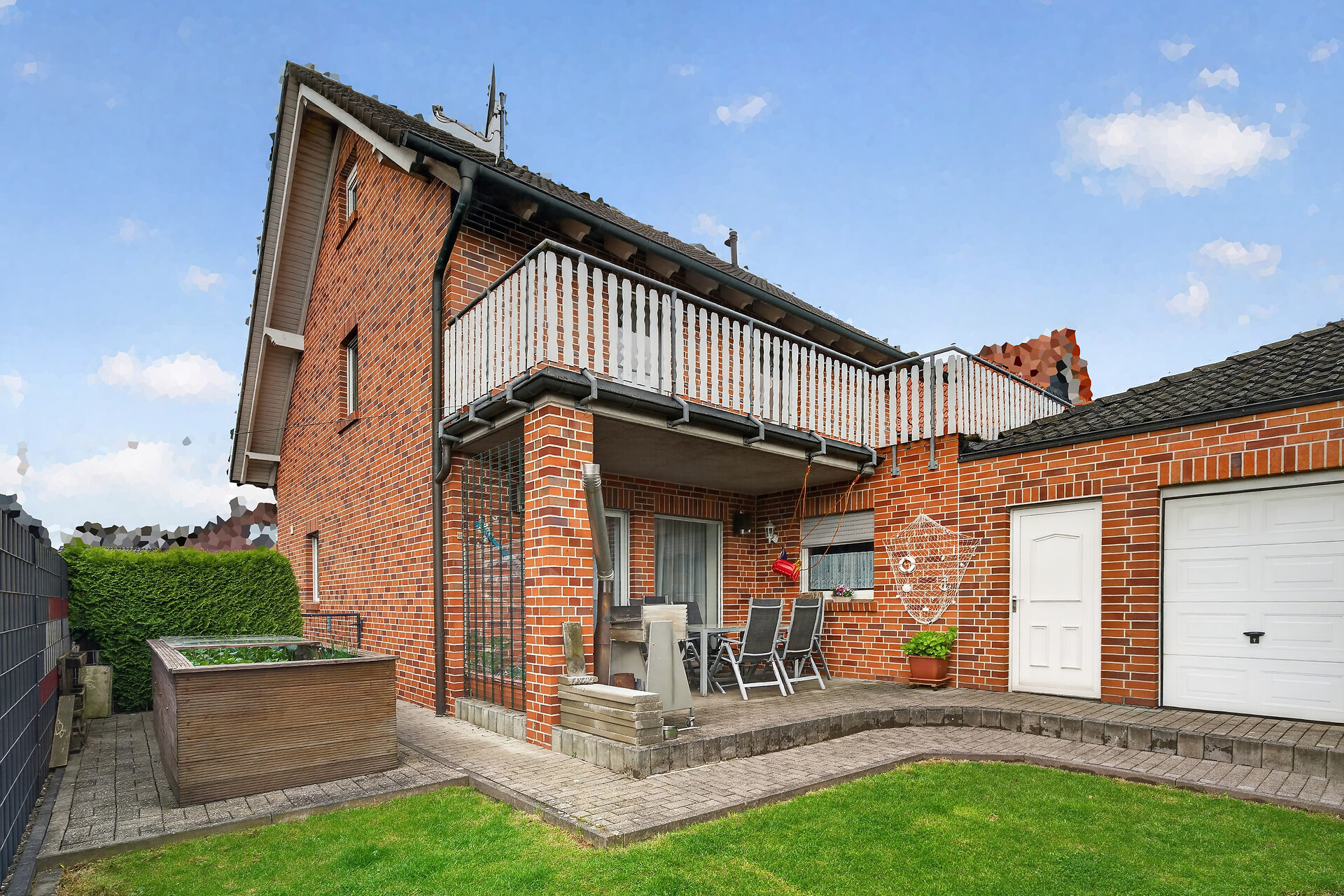 Einfamilienhaus Ascheberg Herbern – Rückansicht mit Balkon, Terrasse und Garage