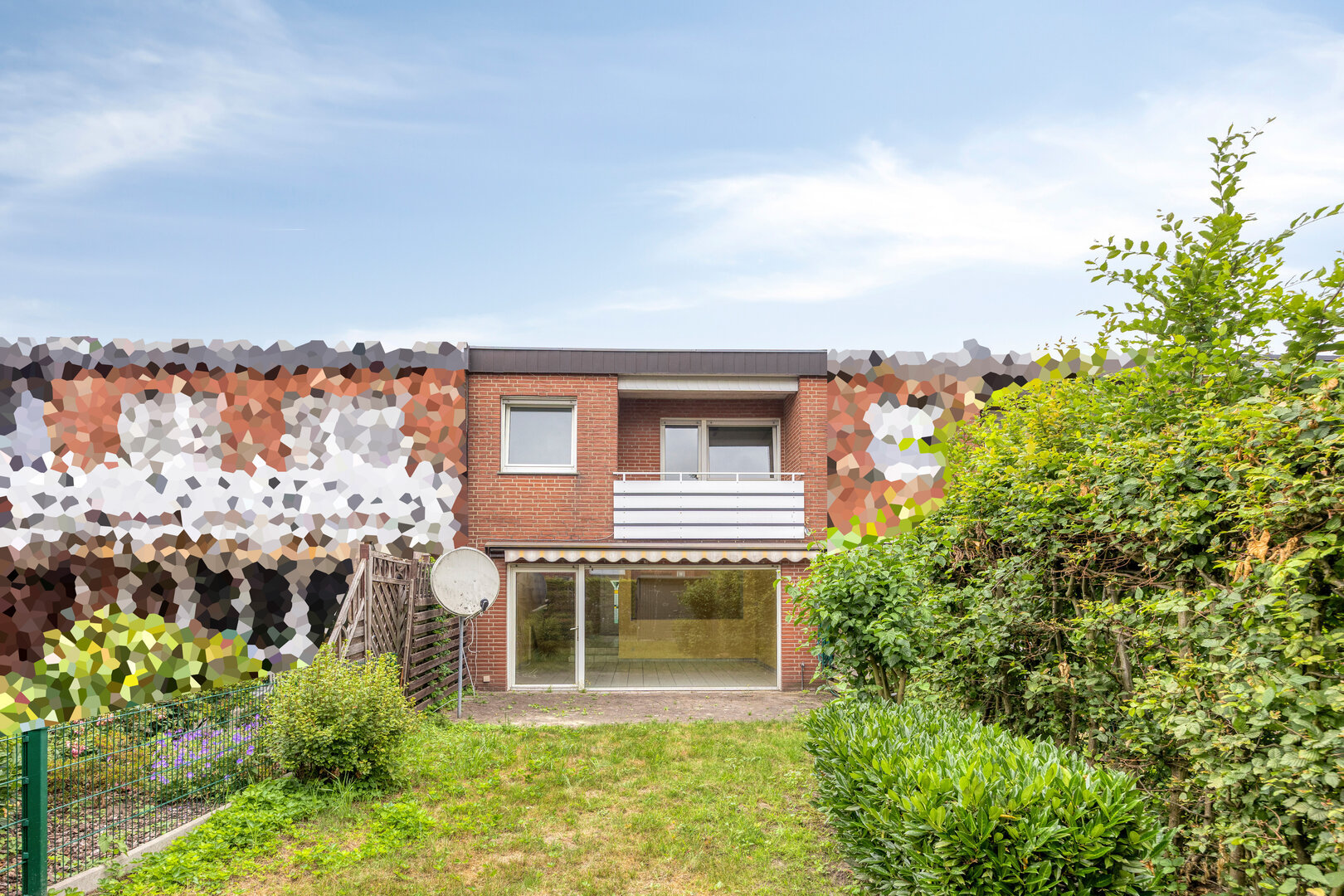 Reihenmittelhaus Münster-Hiltrup – Gartenseite mit Terrasse und Balkon